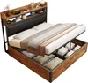 A bed with storage is shown with the storage compartment open, revealing items stored inside. Produktbild-Vorschau