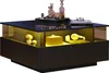 A modern coffee table with a glass display area illuminated by yellow LED lights, showcasing decorative items and headphones. Produktbild-Vorschau