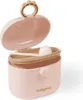 A pink baby food powder container with a beige lid and scoop. Produktbild-Vorschau