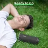 A man is lying on the grass with a speaker next to him. Náhľad obrázku produktu