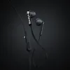 A close-up studio shot of black Urbanista in-ear headphones against a dark background. Produktbild-Vorschau