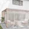 An outdoor patio area with a wooden pergola covered by a transparent screen, furnished with outdoor seating and a coffee table. Anteprima dell’immagine prodotto