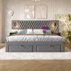 A bedroom scene featuring a large upholstered bed with integrated nightstands and charging features. Produktbild-Vorschau