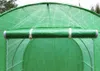 A close-up view of a green tunnel greenhouse, showing a rolled-up mat attached to the top. Náhľad obrázku produktu