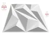 A white 3D wall panel with geometric facets, presented against a white background. Logos are visible on the left and right sides. Produktbild-Vorschau