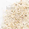 A close-up view of sand grains with a ruler indicating scale. Produktbild-Vorschau