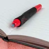 A close-up shot of a black and red pen resting on an open notebook with blue lines. Anteprima dell’immagine prodotto