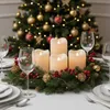 A Christmas-themed table setting with a wreath, candles, wine glasses, and a decorated Christmas tree in the background. Produktbild-Vorschau