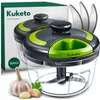 A product shot of a Kuketo hand chopper with garlic and parsley in the foreground. Produktbild-Vorschau