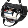 An open black duffel bag filled with various items. Voir les images du produit