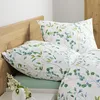 A close-up view of a bed with floral patterned bedding. Produktbild-Vorschau
