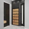 A modern entryway with a dark wood door, a gray and wood shoe cabinet, and a black door with a vertical light strip. Produktbild-Vorschau