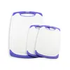 Three white cutting boards with purple trim are arranged in front of a white background. Anteprima dell’immagine prodotto