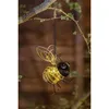 A decorative solar-powered bee lantern hanging from a tree branch. Produktbild-Vorschau
