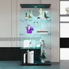 A glass display cabinet with LED lighting, showcasing various decorative items and books. Podgląd zdjęcia produktu