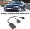 A blue car on a road with snow, and a close-up of an audio adapter cable. Produktbild-Vorschau