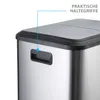 Close-up of the top corner of a stainless steel trash can with a black lid and a black handle. Podgląd zdjęcia produktu