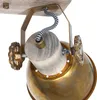 A close-up view of a vintage-style spotlight fixture, showing its brass lamp shade, wooden housing, and decorative metal wheels. Produktbild-Vorschau