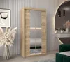 A bedroom scene featuring a wardrobe with mirrored doors, a vanity with a mirror, and decorative elements. Náhled obrázku produktu