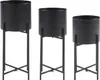 Three black metal plant stands of varying heights are displayed against a white background. Náhled obrázku produktu