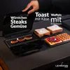 A hand is shown opening a sandwich maker, with sausages grilling inside and prepared sandwiches and waffles displayed next to it. Náhľad obrázku produktu