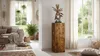 A living room with a wooden pedestal displaying a decorative sculpture, a sofa, plants, and rugs. Anteprima dell’immagine prodotto
