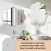 Two decorative mirrors are mounted on a white wall above two sinks in a modern bathroom. Anteprima dell’immagine prodotto