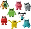 A collection of colorful monster figures and one human-like figure arranged on a white background. Produktbild-Vorschau