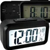 Three black digital alarm clocks are displayed, with the front clock showing the time 12:00. Náhled obrázku produktu