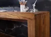 A close-up view of a wooden desk surface with a marble-patterned background visible underneath. Náhled obrázku produktu