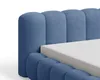 Close-up of a blue upholstered bed frame with a mattress. Voir les images du produit