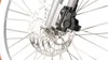 A close-up view of a bicycle's front wheel brake system, including the disc rotor and caliper, against a white background. Anteprima dell’immagine prodotto