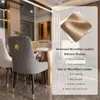 A dining room setting with chairs and a table, featuring marketing text about the chair material. Podgląd zdjęcia produktu