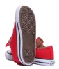 A pair of red Converse Chuck Taylor All Star sneakers shown from a low angle, with one shoe's sole prominently displayed. Voir les images du produit