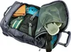 An open duffel bag with various items packed inside, including clothing and footwear. Produktbild-Vorschau