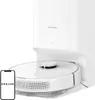 A white Dreame robot vacuum cleaner is docked in its charging station, with a smartphone displaying the Dreame logo in the foreground. Voir les images du produit