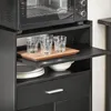 A close-up view of a kitchen cabinet with a microwave on top, showing a pull-out shelf with glasses and a cutting board, and plates and bowls on the shelf below. Anteprima dell’immagine prodotto