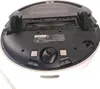 The underside of a robot vacuum cleaner. Voir les images du produit