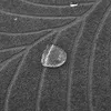 A close-up shot of a gray textured fabric with water droplets on it. Produktbild-Vorschau