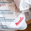A close-up of a white duvet with a branded label. Produktbild-Vorschau