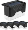 A set of four solar-powered garden lights, with one light prominently displayed above the other three. Podgląd zdjęcia produktu
