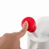 A close-up of a finger pressing a red button on a white object. Produktbild-Vorschau