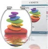 A toilet seat with a colorful stone stacking design, shown with its packaging. Náhled obrázku produktu