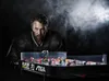 A man in a hockey jersey leans over a table hockey game. Náhľad obrázku produktu