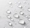 Close-up view of water droplets on a white fabric surface. Produktbild-Vorschau