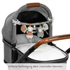 A close-up view of a baby stroller with a toy chain attached to the canopy. Produktbild-Vorschau