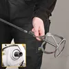A person is holding a mixing attachment for a power tool, showing how it connects. Náhled obrázku produktu