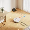 A robot vacuum cleaner is shown in a room with a charging dock, a table, and a chair. The image includes graphics indicating the vacuum's path and battery information. Náhled obrázku produktu