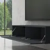 A modern black floating TV stand with two open compartments, one with a door propped open by a gas strut, mounted on a textured gray wall. A large flat-screen TV is mounted above the stand. A large window with greenery is visible to the left. Voir les images du produit