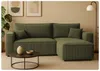 A green sectional sofa is shown in a living room setting with artwork and a plant. Náhled obrázku produktu